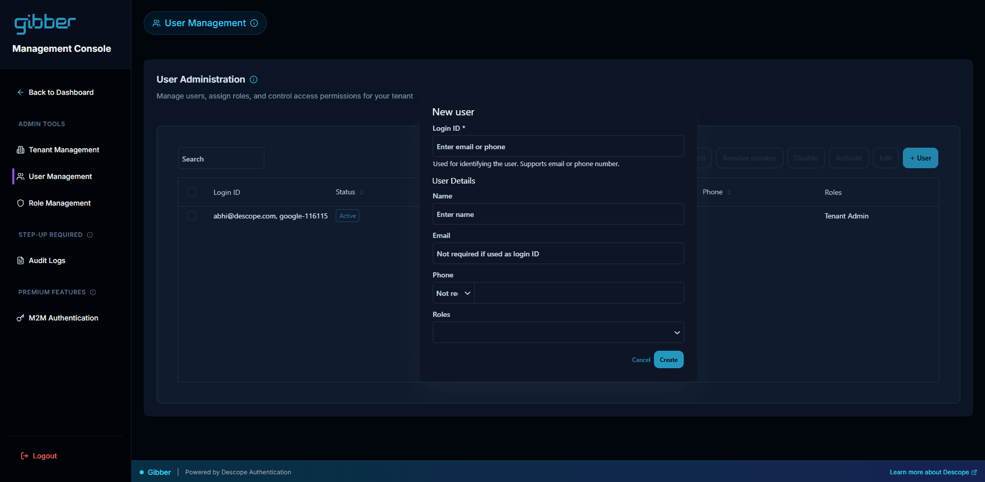 A screenshot of a software dashboard titled Management Console for a company called gibber. The interface displays a User Administration page used to manage users, assign roles, and control access permissions for a tenant. A sidebar on the left includes navigation options such as Tenant Management, User Management, Role Management, Audit Logs, and M2M Authentication. In the center, a New user modal window is open over the user list. The modal includes input fields for Login ID, Name, Email, Phone, and Roles, with buttons at the bottom to Cancel or Create. The background user list shows an entry for abhi@descope.com with an Active status and the role of Tenant Admin. At the very bottom, a footer bar states Gibber | Powered by Descope Authentication and includes a link to Learn more about Descope.